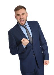 Young businessman celebrating victory on white background