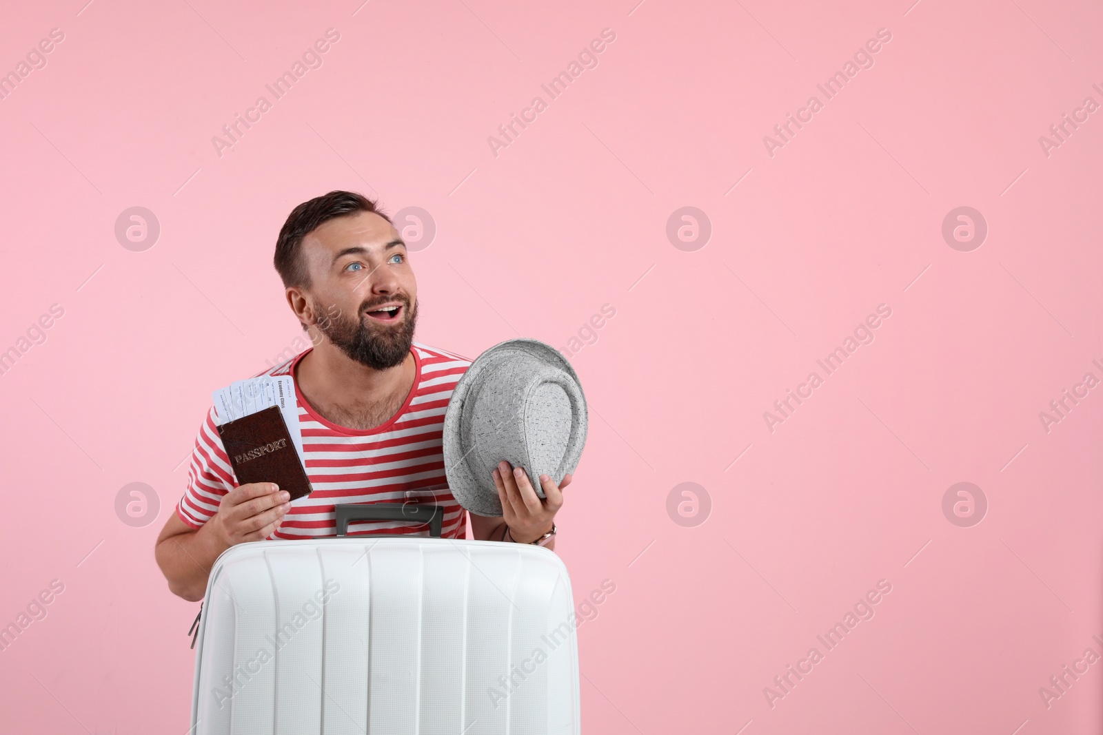 Photo of Man with suitcase, passport and hat on color background. Space for text