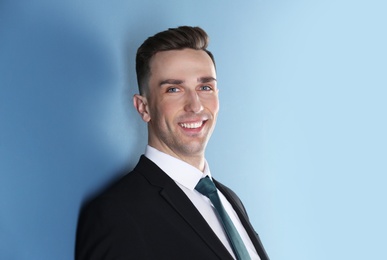 Photo of Portrait of young man with beautiful hair on color background