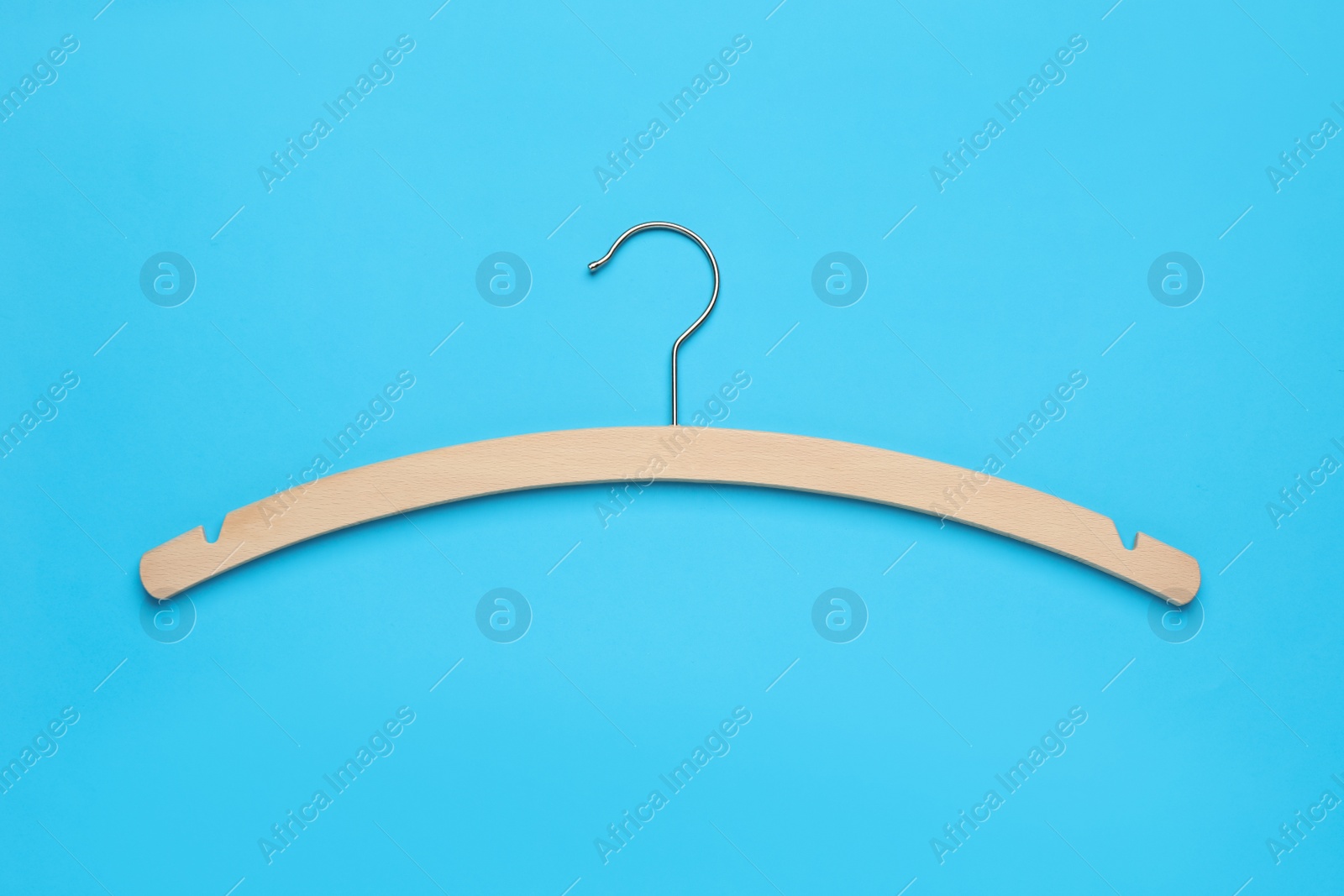 Photo of Empty hanger on light blue background, top view