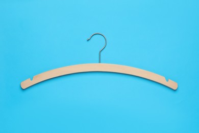 Photo of Empty hanger on light blue background, top view