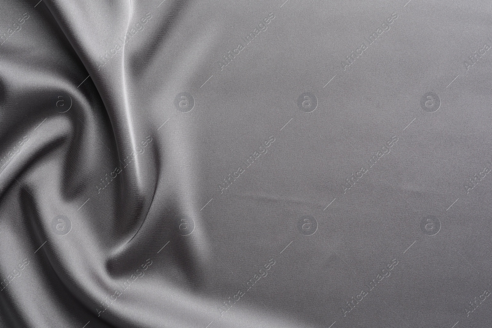 Photo of Texture of beautiful light grey silk fabric as background, closeup