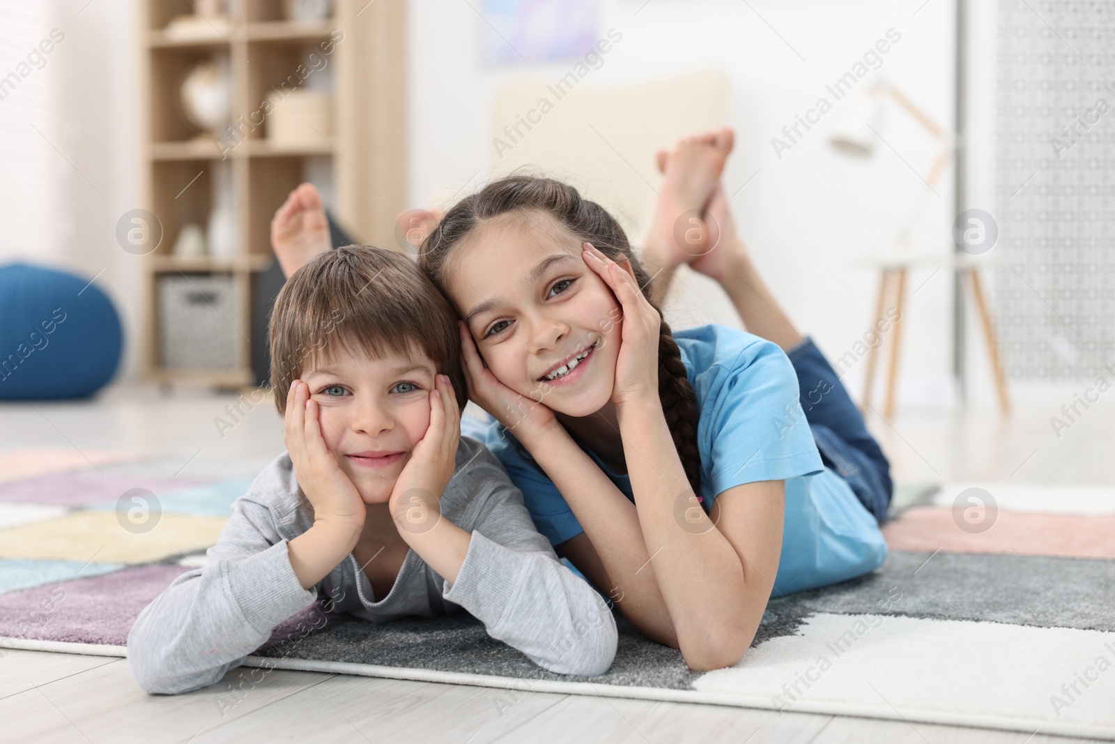 Photo of Happy brother and sister spending time together at home