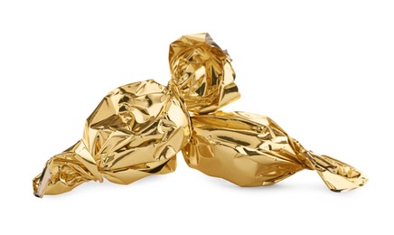 Photo of Candies in golden wrappers isolated on white