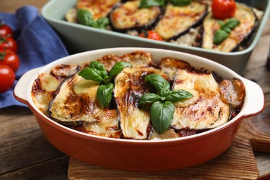 Photo of Delicious eggplant lasagna in baking dish on wooden table