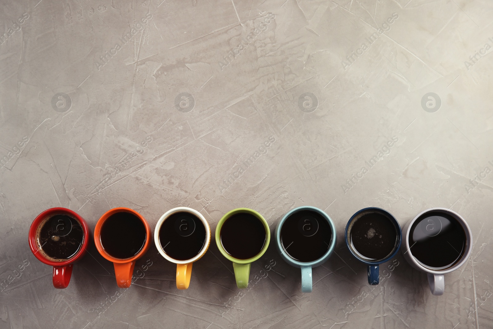 Photo of Flat lay composition with cups of coffee on gray background. Food photography