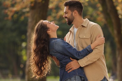 Beautiful couple spending time together in autumn park