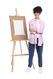 Photo of Young woman holding brush near easel against white background