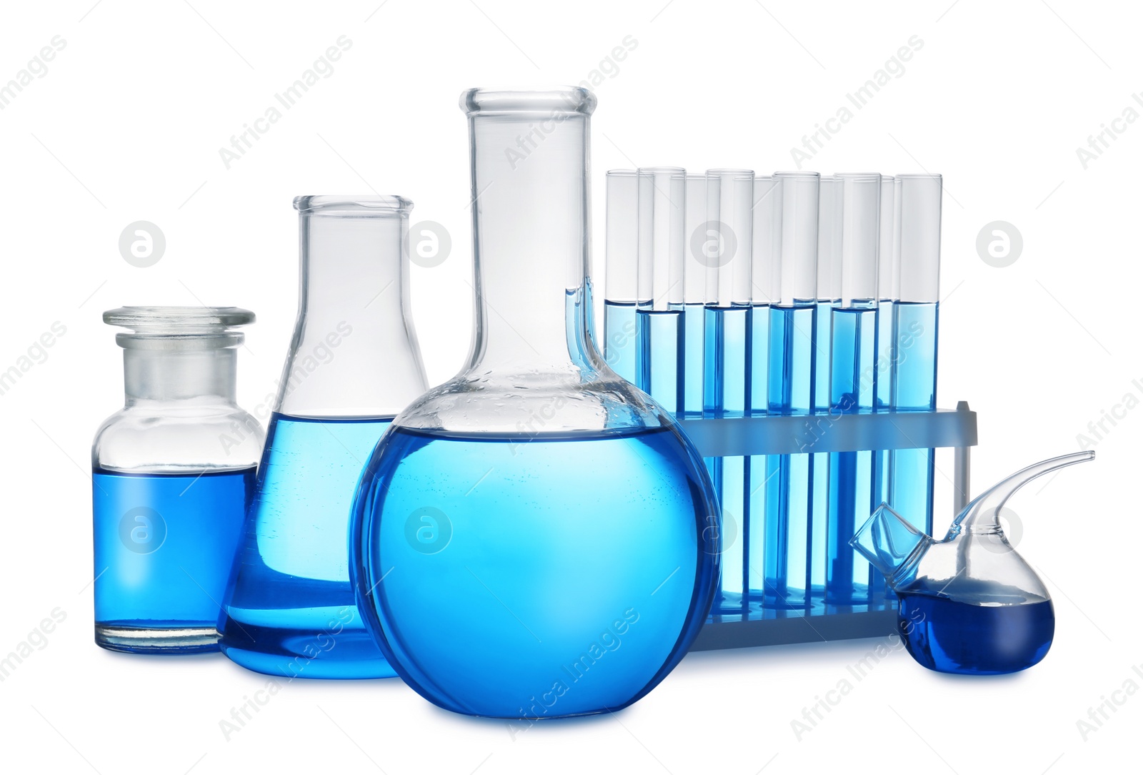 Photo of Set of laboratory glassware with blue liquid on white background