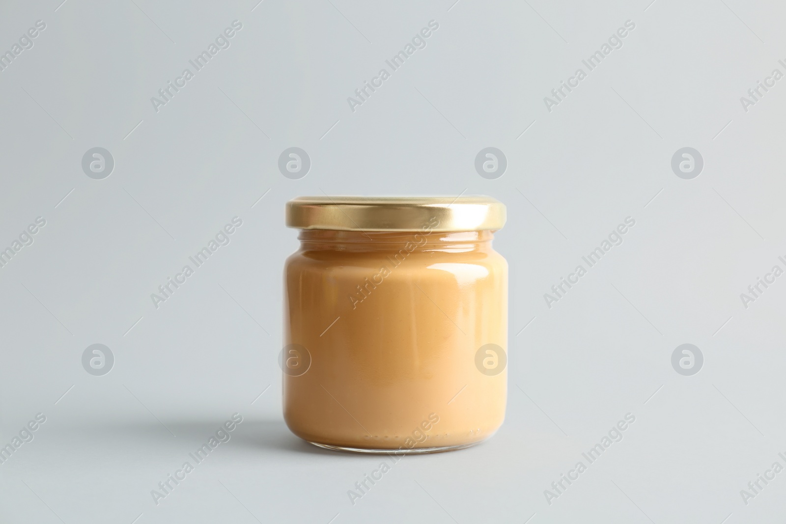 Photo of Jar of peanut butter on white background