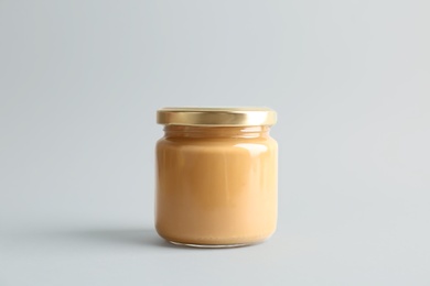 Jar of peanut butter on white background