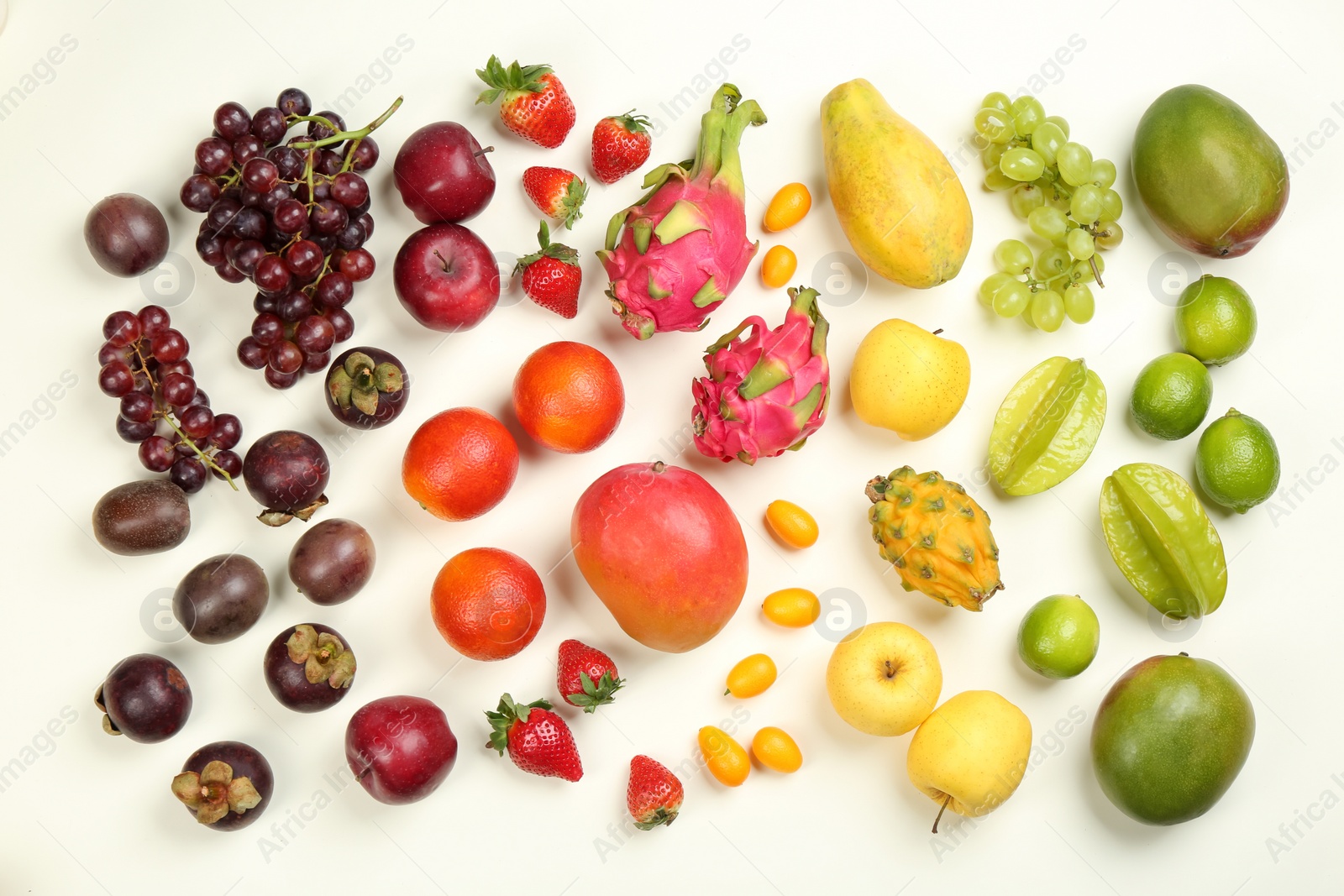 Photo of Assortment of fresh exotic fruits on white background, flat lay