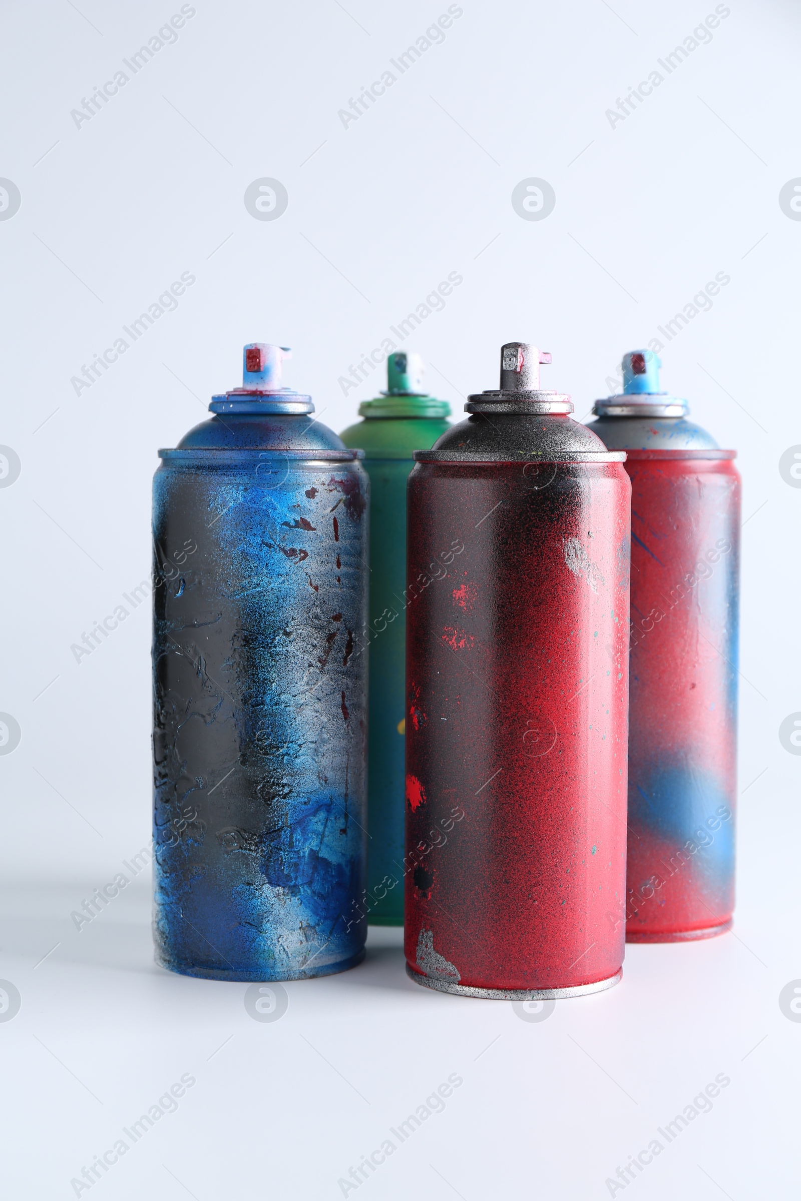 Photo of Many spray paint cans on white background