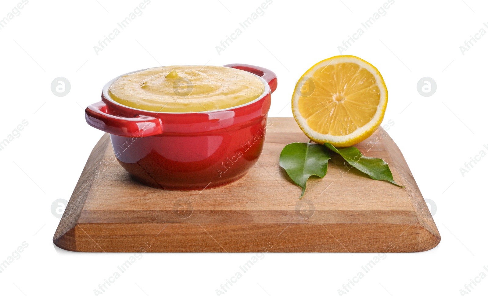 Photo of Delicious lemon curd in bowl, fresh citrus fruit and green leaves isolated on white