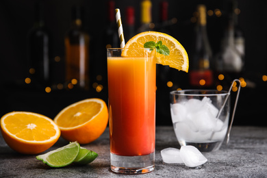 Fresh alcoholic Tequila Sunrise cocktail on grey table