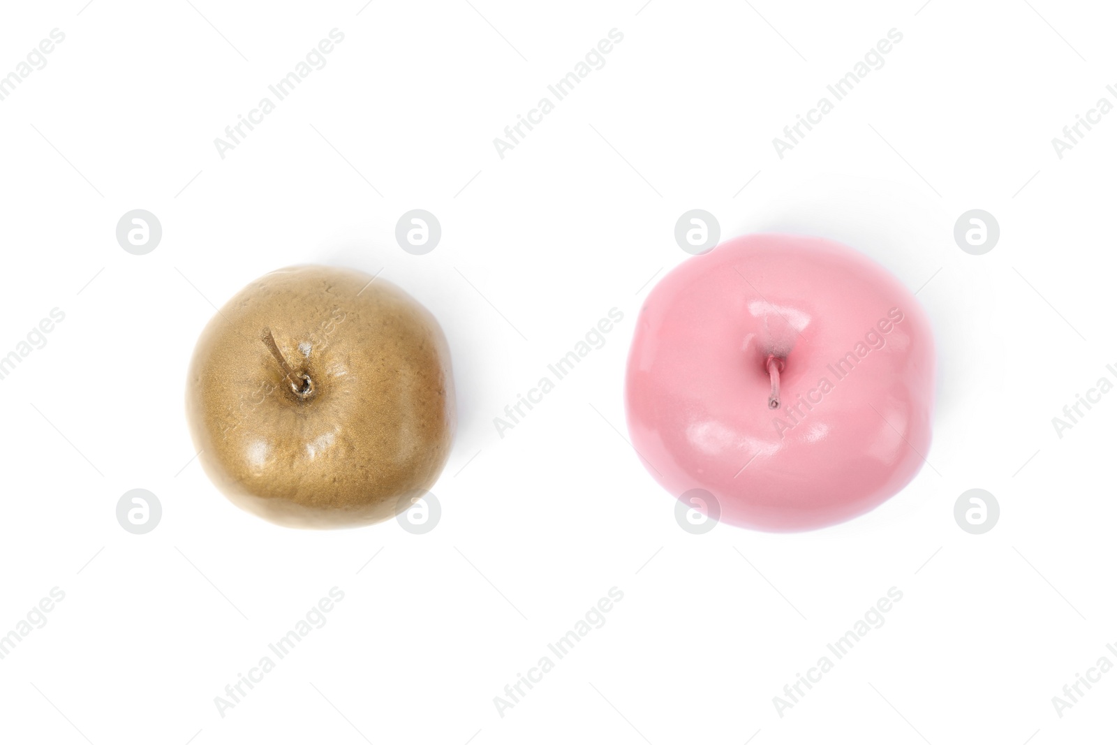 Photo of Shiny stylish gold and pink apples on white background, top view