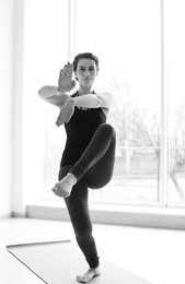 Photo of Sporty woman practicing yoga indoors