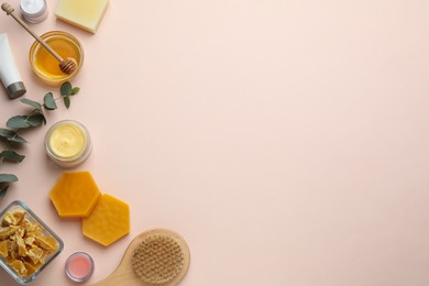 Photo of Flat lay composition with beeswax and cosmetic products on beige background. Space for text