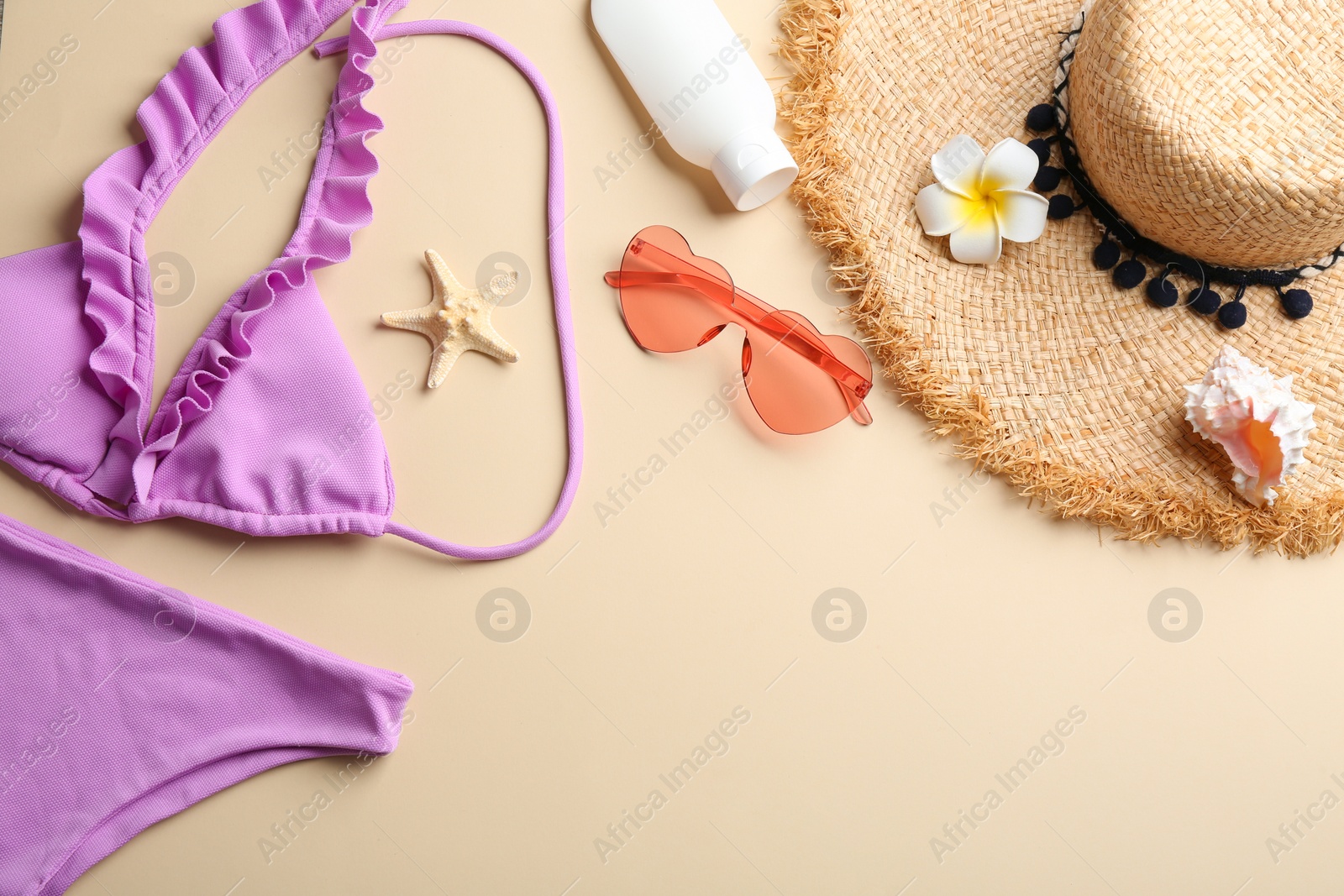 Photo of Flat lay composition with beach accessories on color background. Space for text