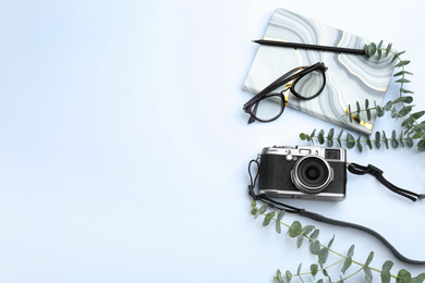 Photo of Camera for professional photographer and accessories on white background, top view
