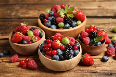 Photo of Mix of ripe berries on wooden table