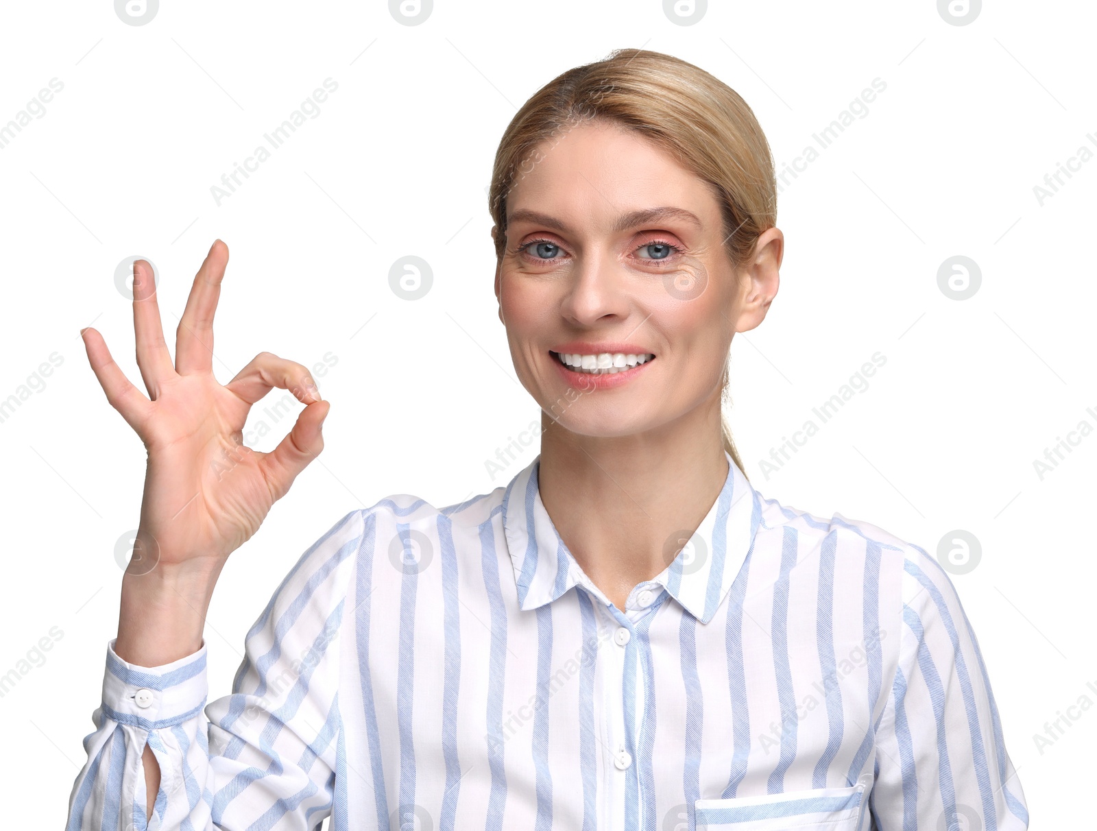 Photo of Woman with clean teeth smiling and showing OK gesture on white background
