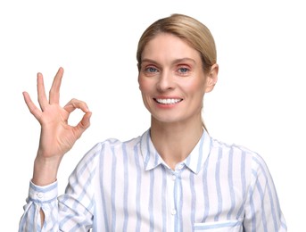 Woman with clean teeth smiling and showing OK gesture on white background