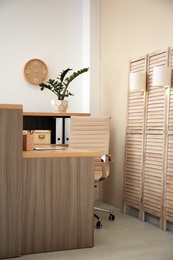 Photo of Receptionist desk in hotel. Workplace interior
