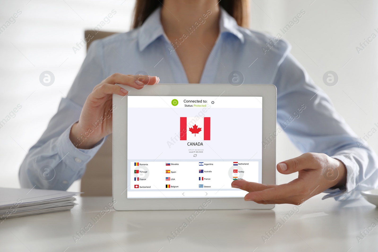 Image of Woman holding modern tablet with switched on VPN at white table in office, closeup