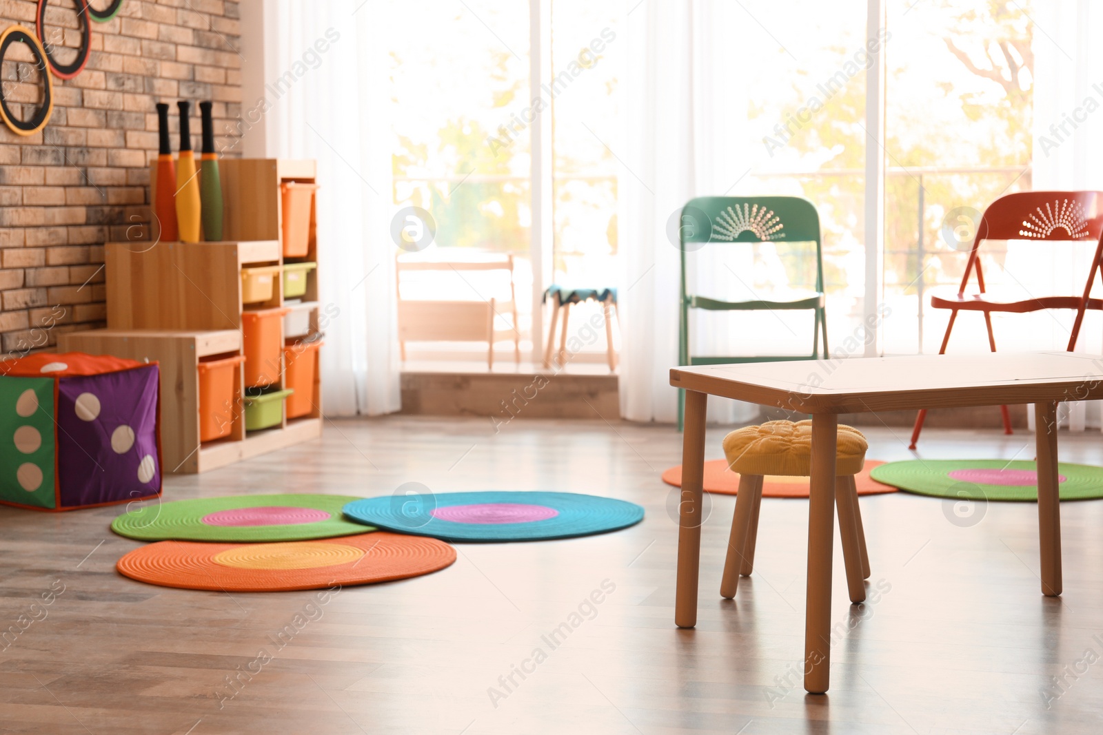 Photo of Stylish child room interior with colorful furniture