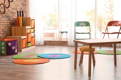 Photo of Stylish child room interior with colorful furniture