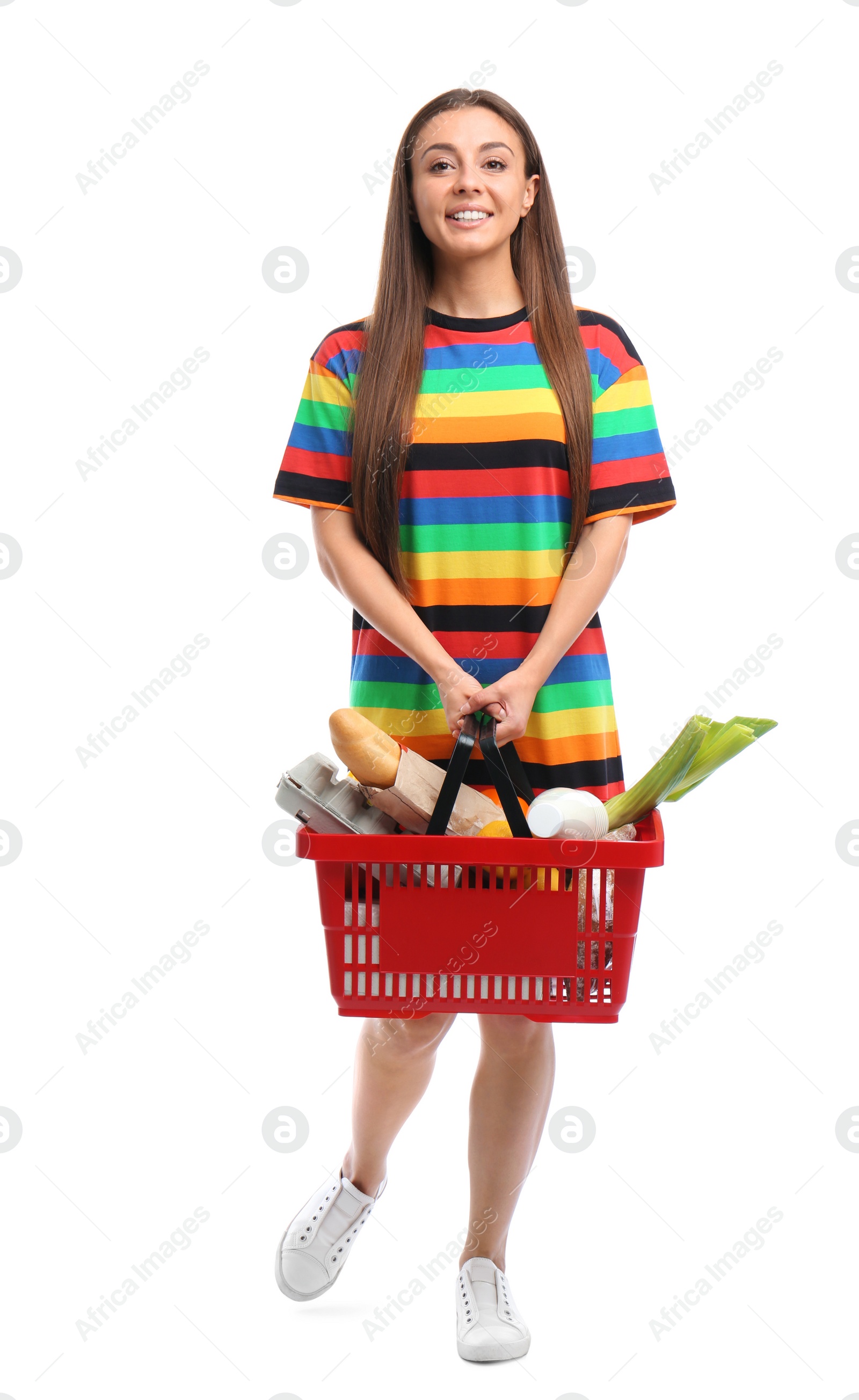 Photo of Young woman with shopping basket full of products isolated on white