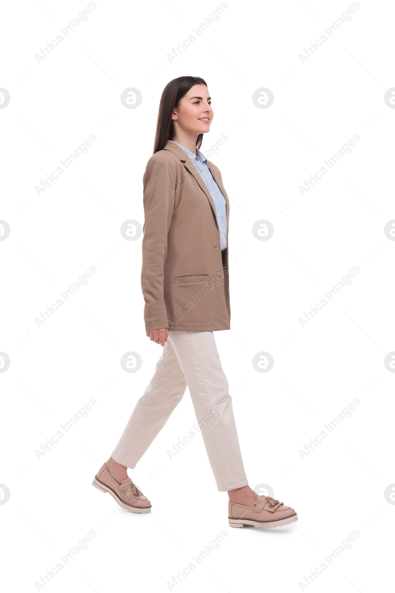 Photo of Beautiful young businesswoman walking on white background