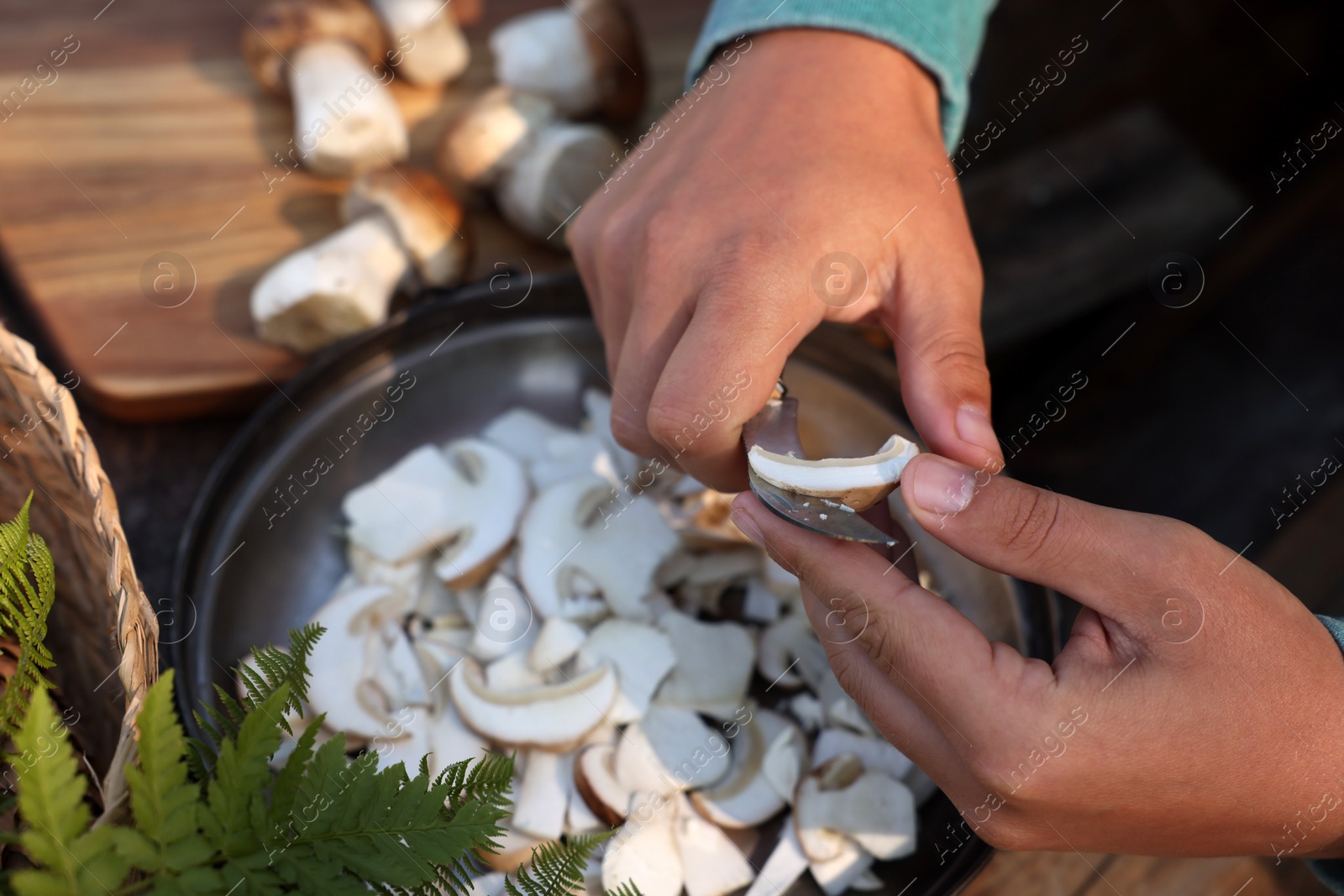 Photo of Man slicing mushrooms at table, closeup view