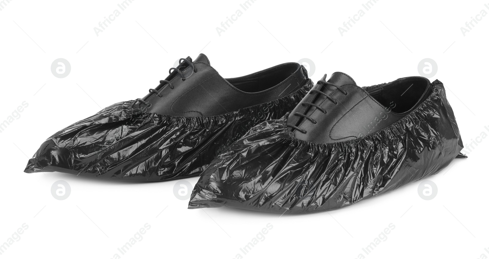 Photo of Men's shoes in black shoe covers isolated on white