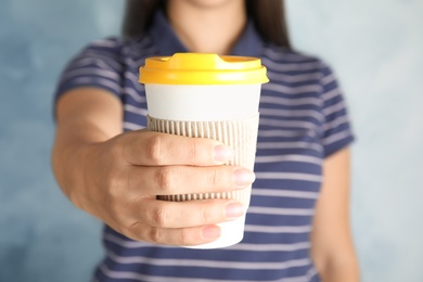 Photo of Woman with carton cup, closeup. Mock up for design