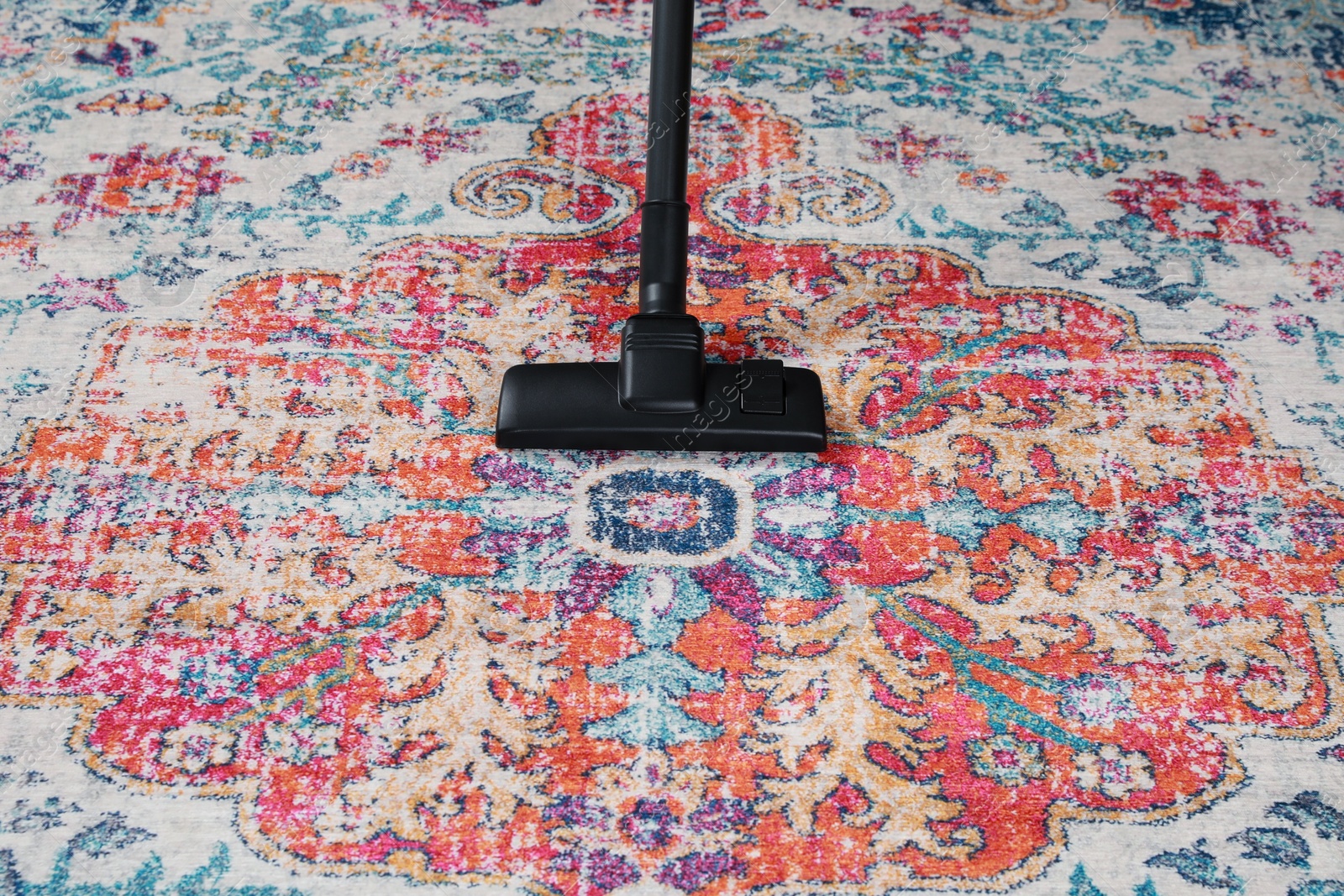 Photo of Removing dirt from carpet with modern vacuum cleaner. Space for text