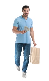 Photo of Handsome young man with dollars and shopping bag on white background