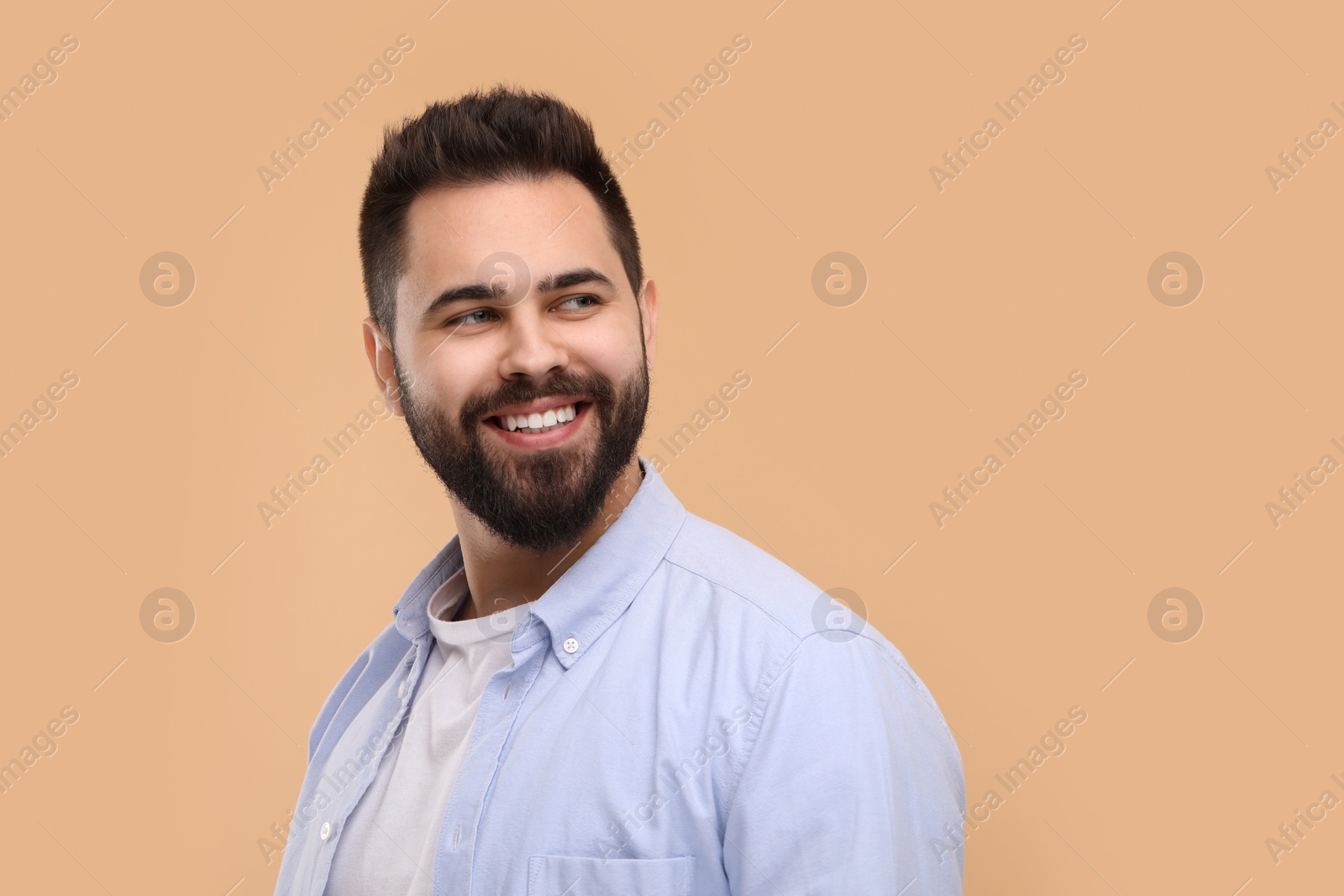 Photo of Man with clean teeth smiling on beige background
