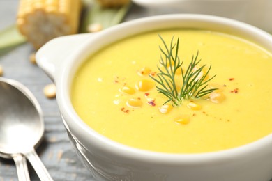 Photo of Delicious creamy corn soup on table, closeup