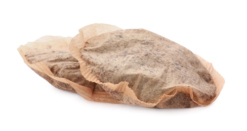 Two used tea bags on white background