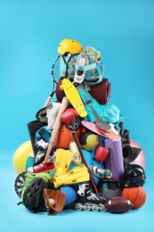 Photo of Many different sports equipment on light blue background