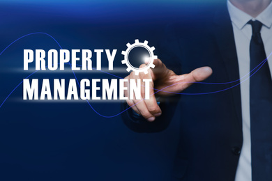 Property management concept. Man using virtual screen with gear icon, closeup