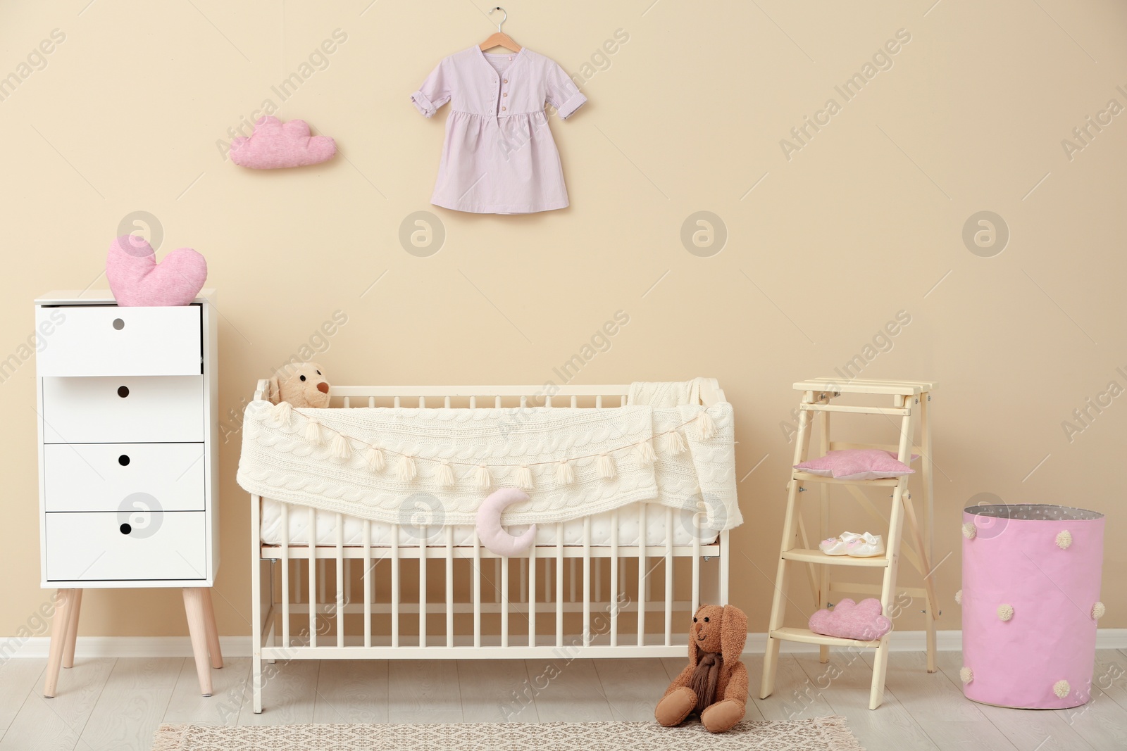 Photo of Stylish baby room interior with comfortable crib