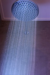 Photo of Luxury shower with water flowing in bathroom