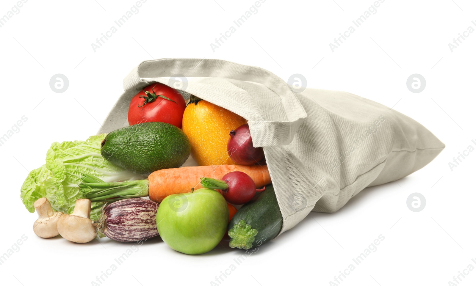 Photo of Overturned cloth bag with vegetables on white background