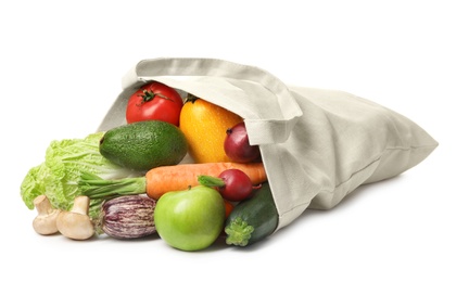 Overturned cloth bag with vegetables on white background