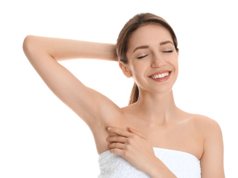 Young woman showing armpit with smooth clean skin on white background