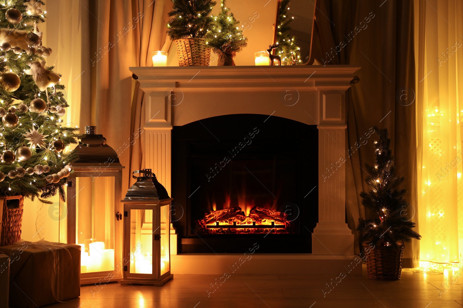 Photo of Beautiful fireplace, Christmas tree and other decorations in living room at night. Interior design