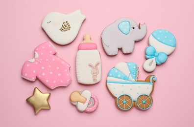 Set of baby shower cookies on light pink background, flat lay